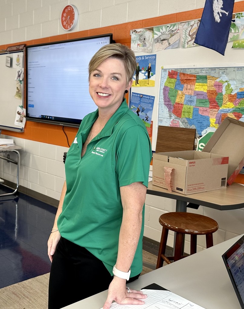 Smiling lady in a green shirt. 