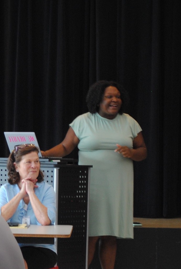 Mrs. Jill Jett and Ms. Kishni Neville listening to the new principal.