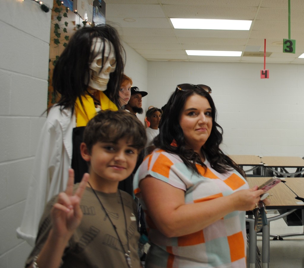 Family listening to science teacher.