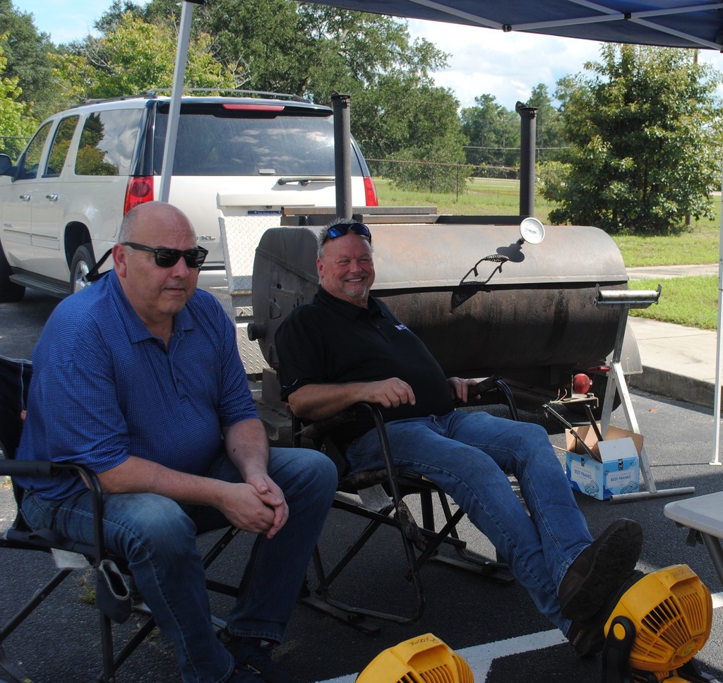 Mr. Jim Broome chilling after grilling hot dogs in the heat for Open House event.