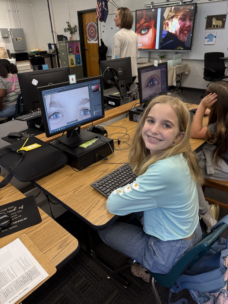 student editing pictures on computer 