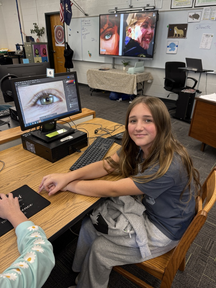 student editing pictures on computer 