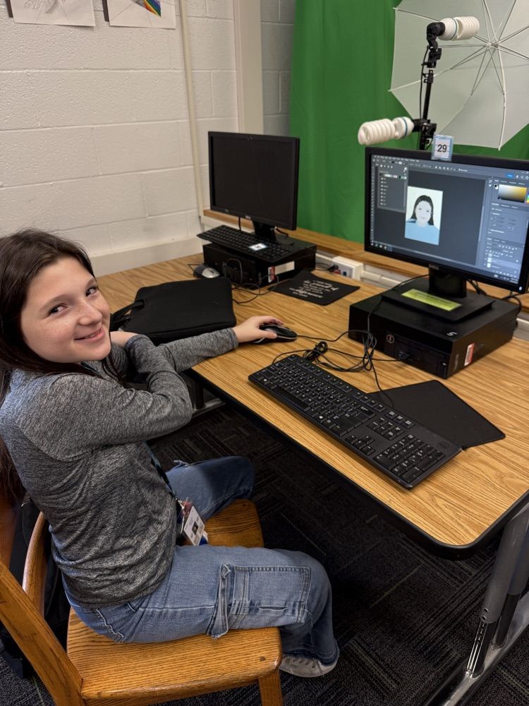 student editing pictures on computer 