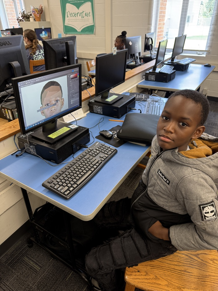 student editing pictures on computer 