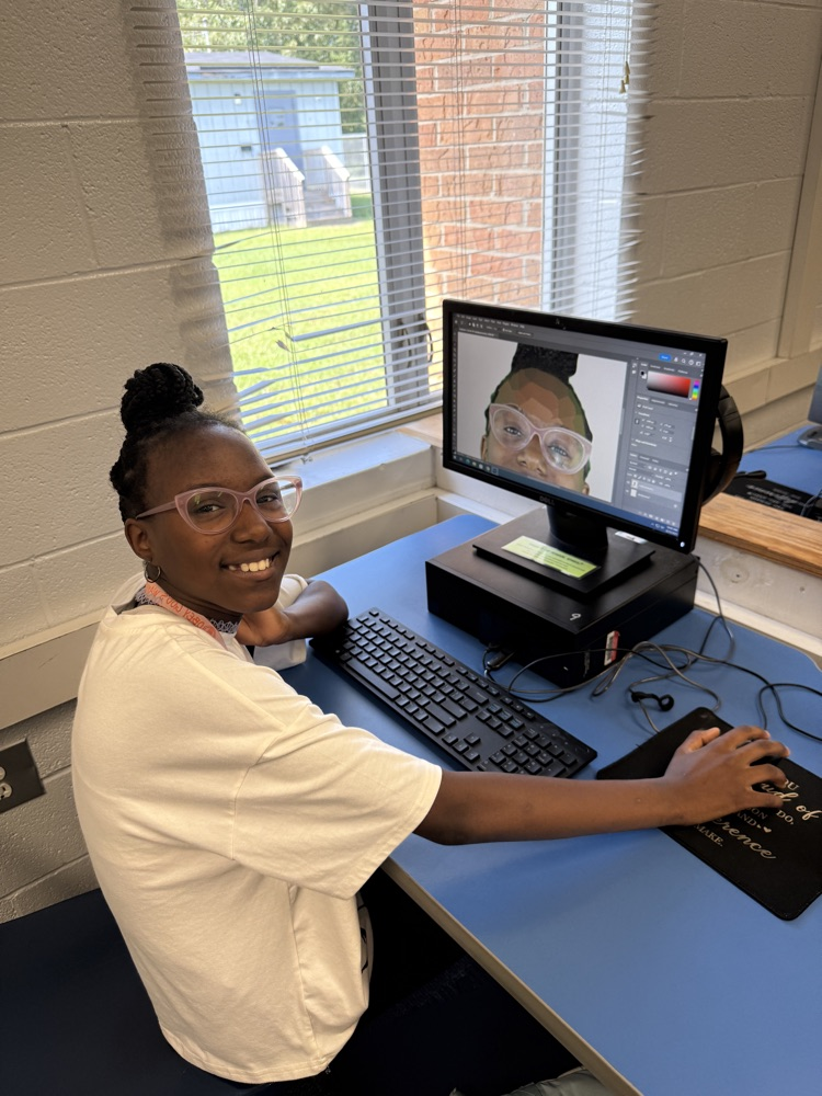 student editing pictures on computer 