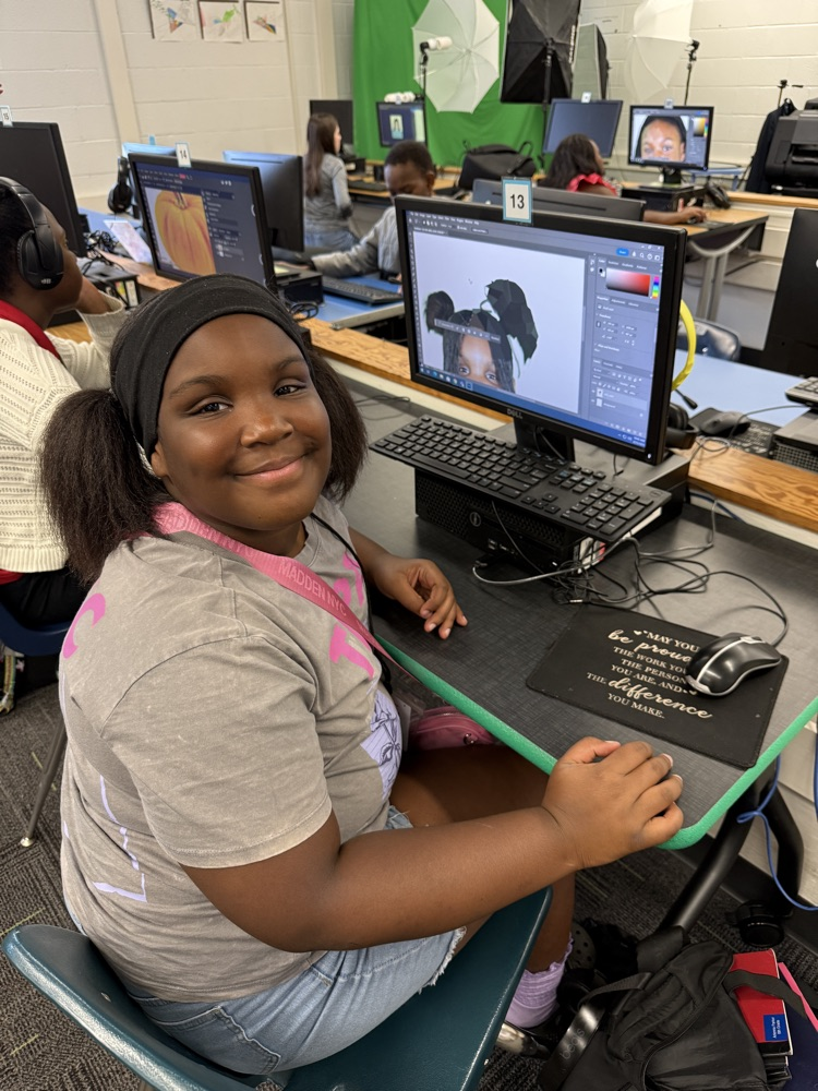student editing pictures on computer 