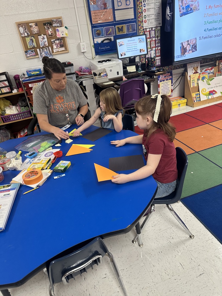 Students and teacher at table.