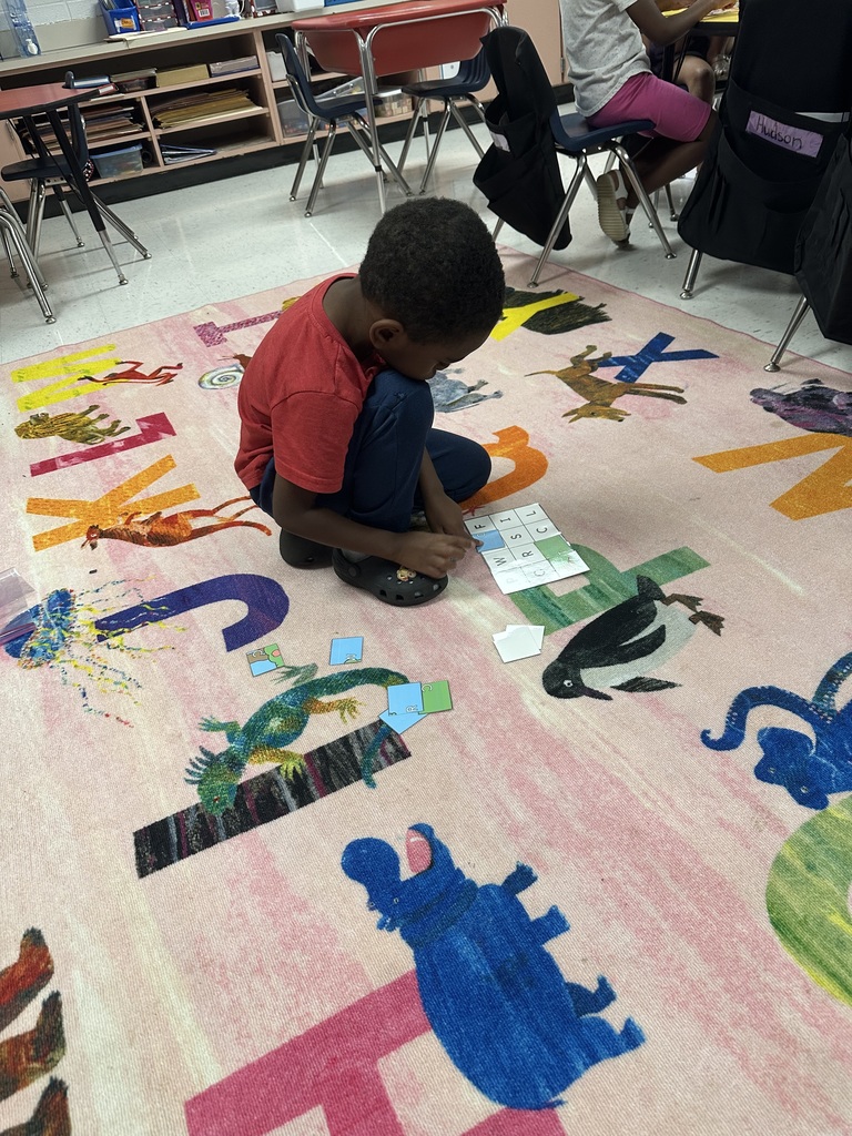 Student working on floor.