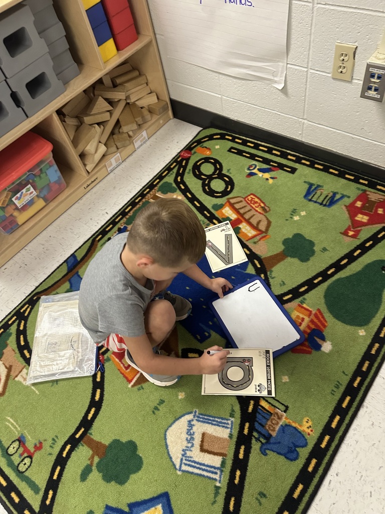 Student working on floor.