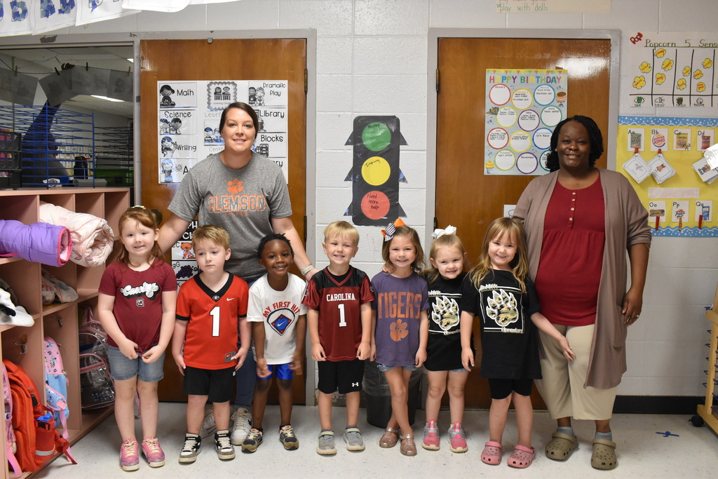 Students and teachers in team attire.