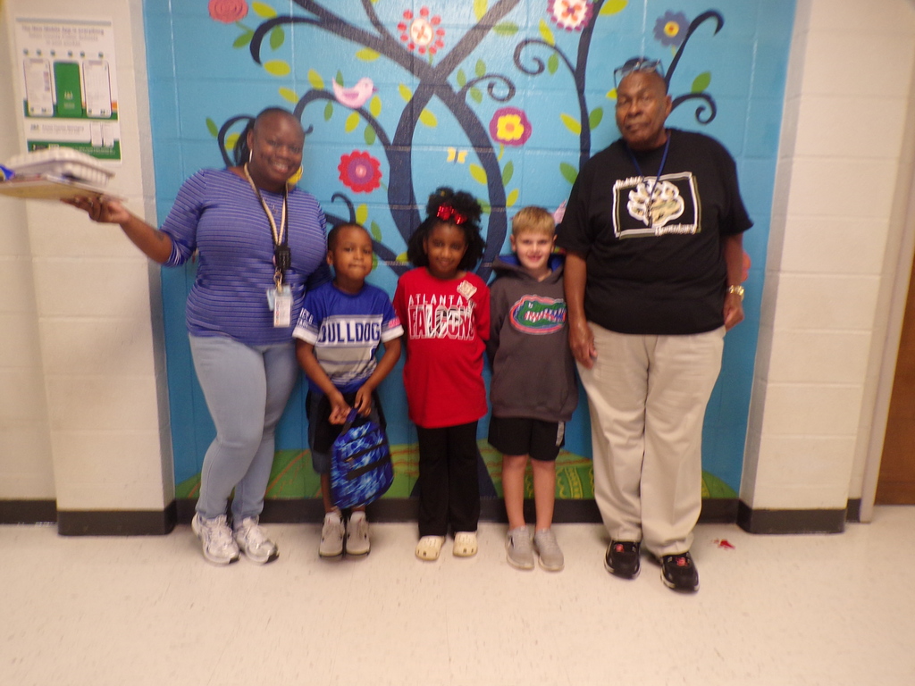 Students and teachers in team attire.