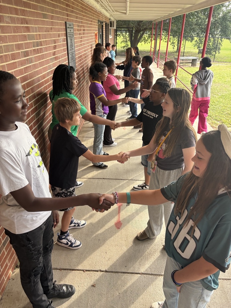 AVID students practice shaking hands and making eye contact.
