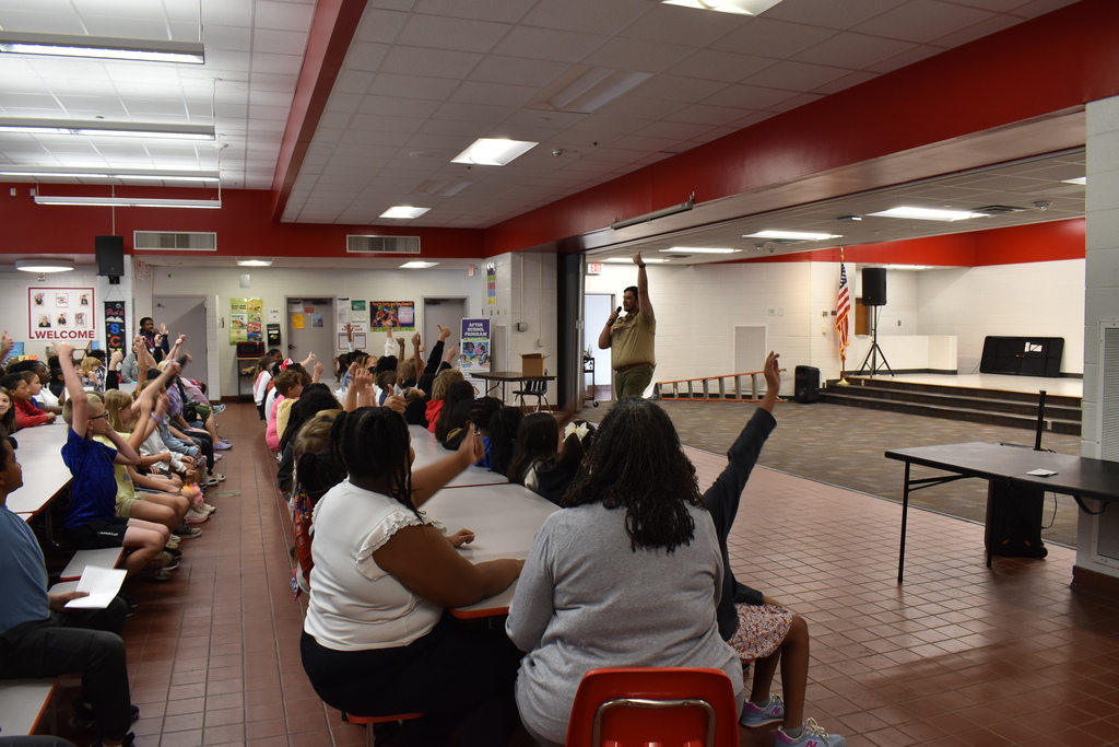 Speakers in front of student audience.