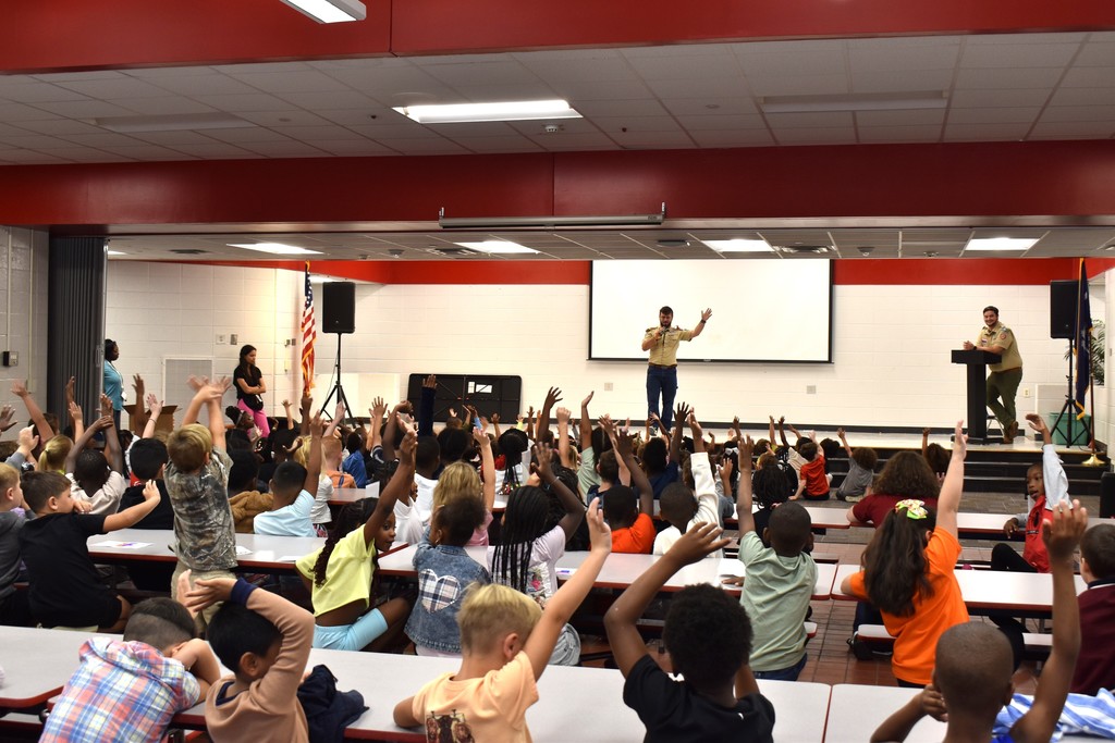 Speakers in front of student audience.