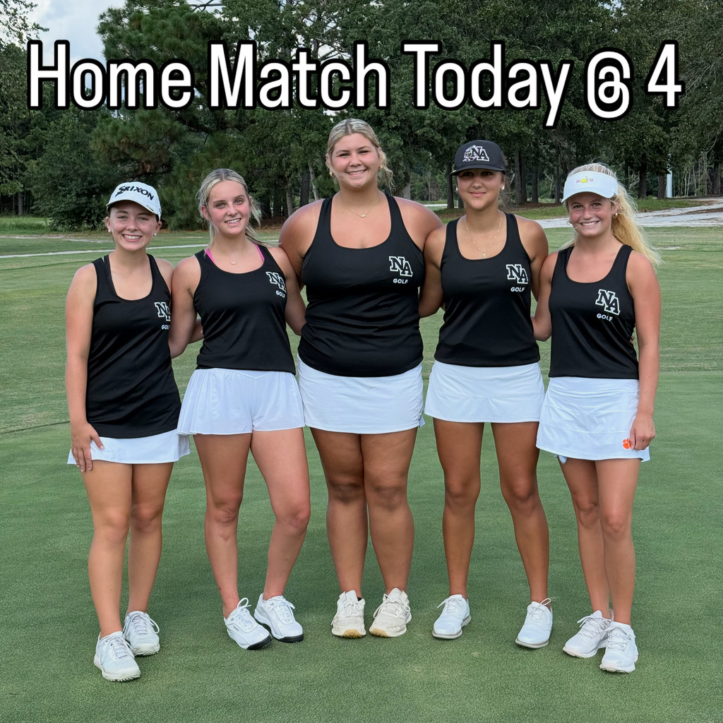 5 Girls posing in golf outfits on fairway.