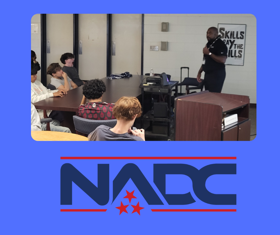 Students listen to a presentation from a college recruiter