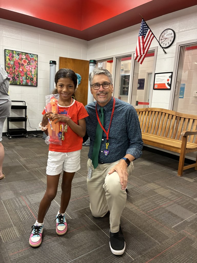 Student and principal with chicken.