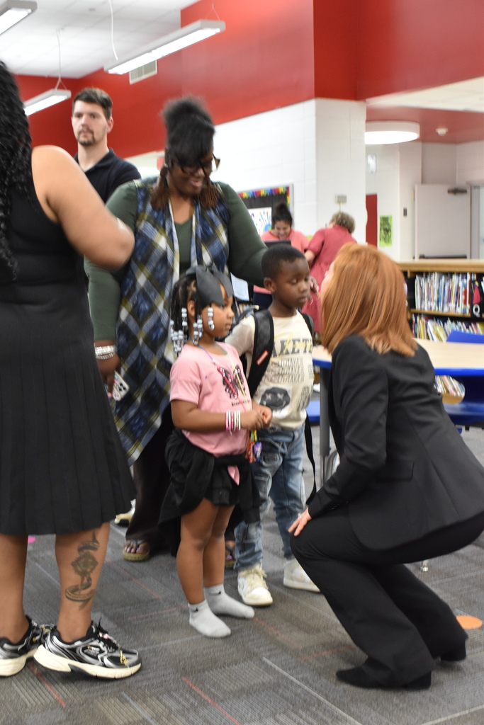 Principal talking to students and staff.