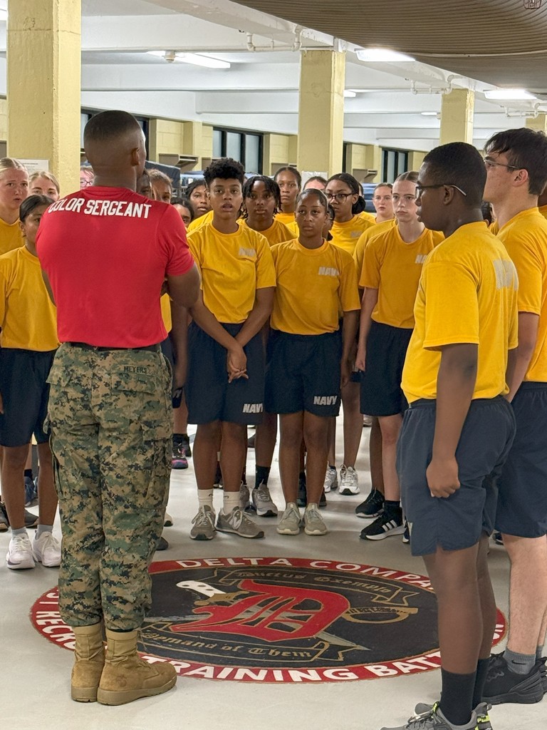 Military Recruits listening to drill instructor in barracks.