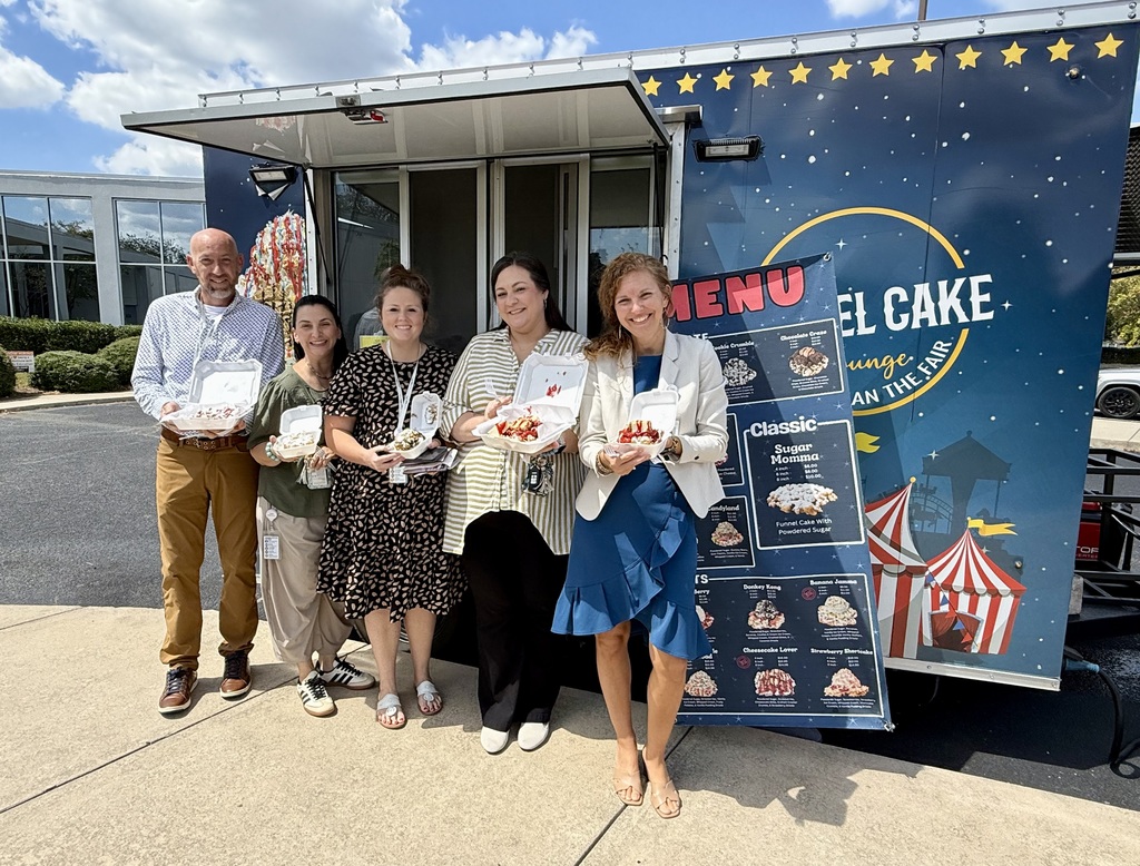 Five HR staff members outside with funnel cakes.