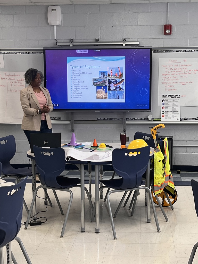 Ms. Toney standing near the smartboard