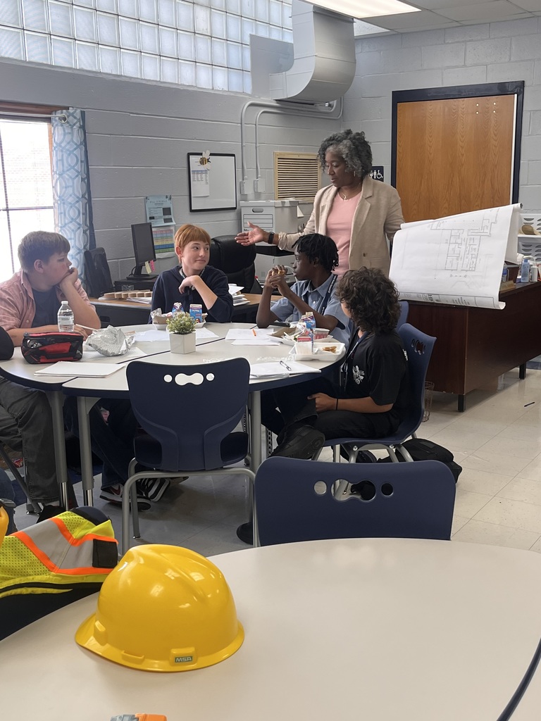 Ms. Toney talking with several students