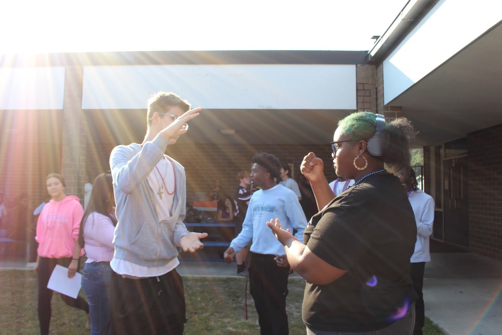 Students playing rock paper scissors