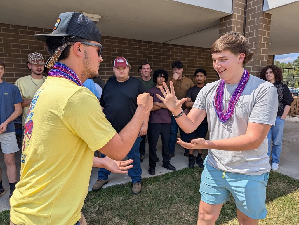 Students playing rock paper scissors