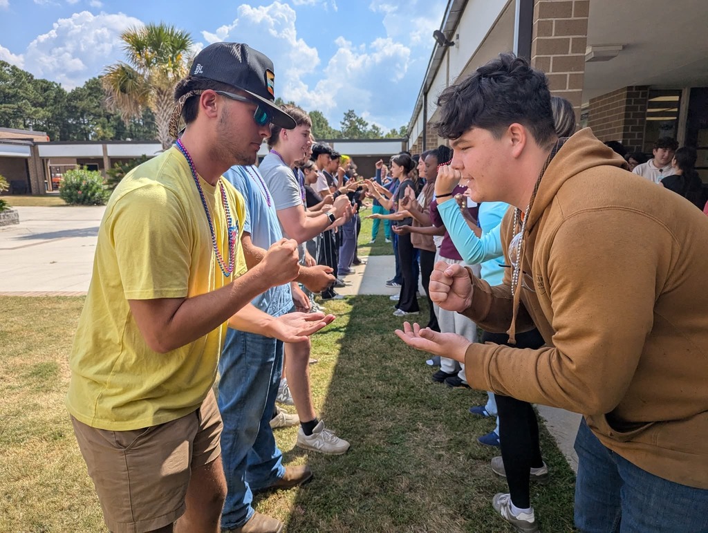 Students playing rock paper scissors