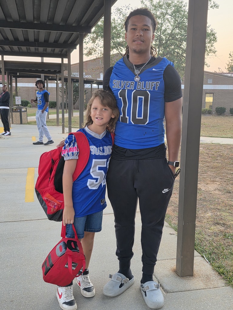 Football player with younger player.