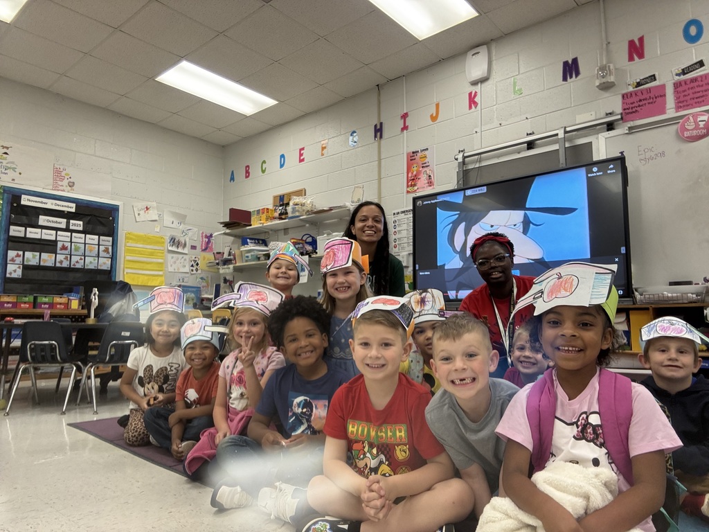 Students wearing apple hats.