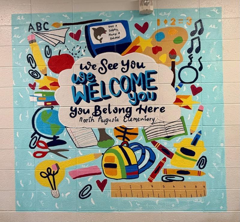 New Front Mural “We See You. We Welcome You. You Belong Here. North Augusta Elementary.” It also proudly features our reminder: “Once a Dolphin, Always a Dolphin!”