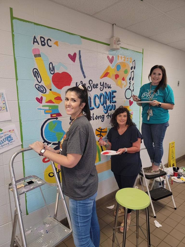 Teachers working on New Front Mural “We See You. We Welcome You. You Belong Here. North Augusta Elementary.” It also proudly features our reminder: “Once a Dolphin, Always a Dolphin!”