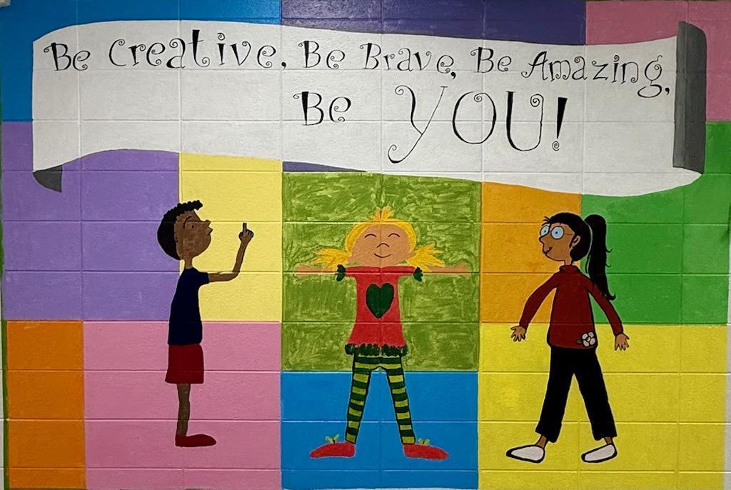 New back hallway mural “Be Creative. Be Brave. Be Amazing. Be You!” Three students are pictured shining with confidence, encouraging all of us to embrace who we are.