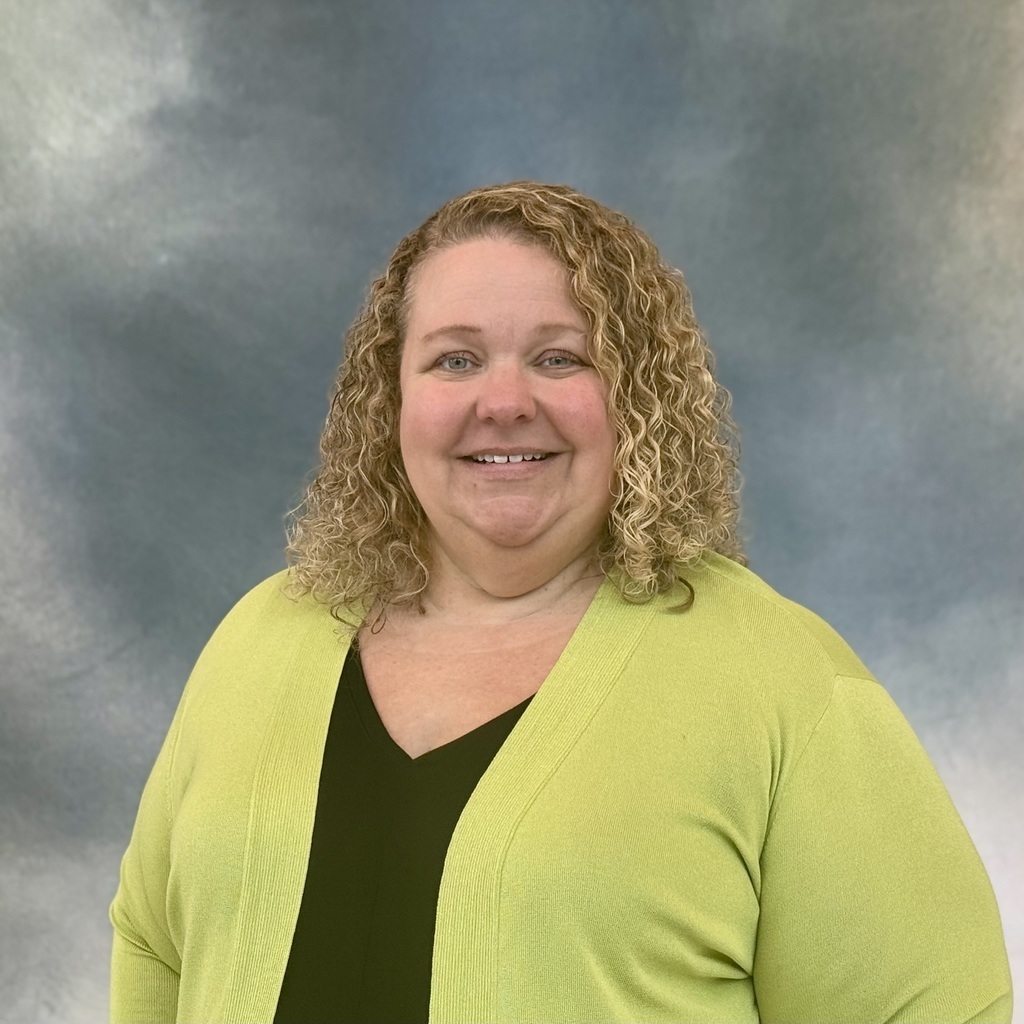 Smiling lady in a green jacket. 