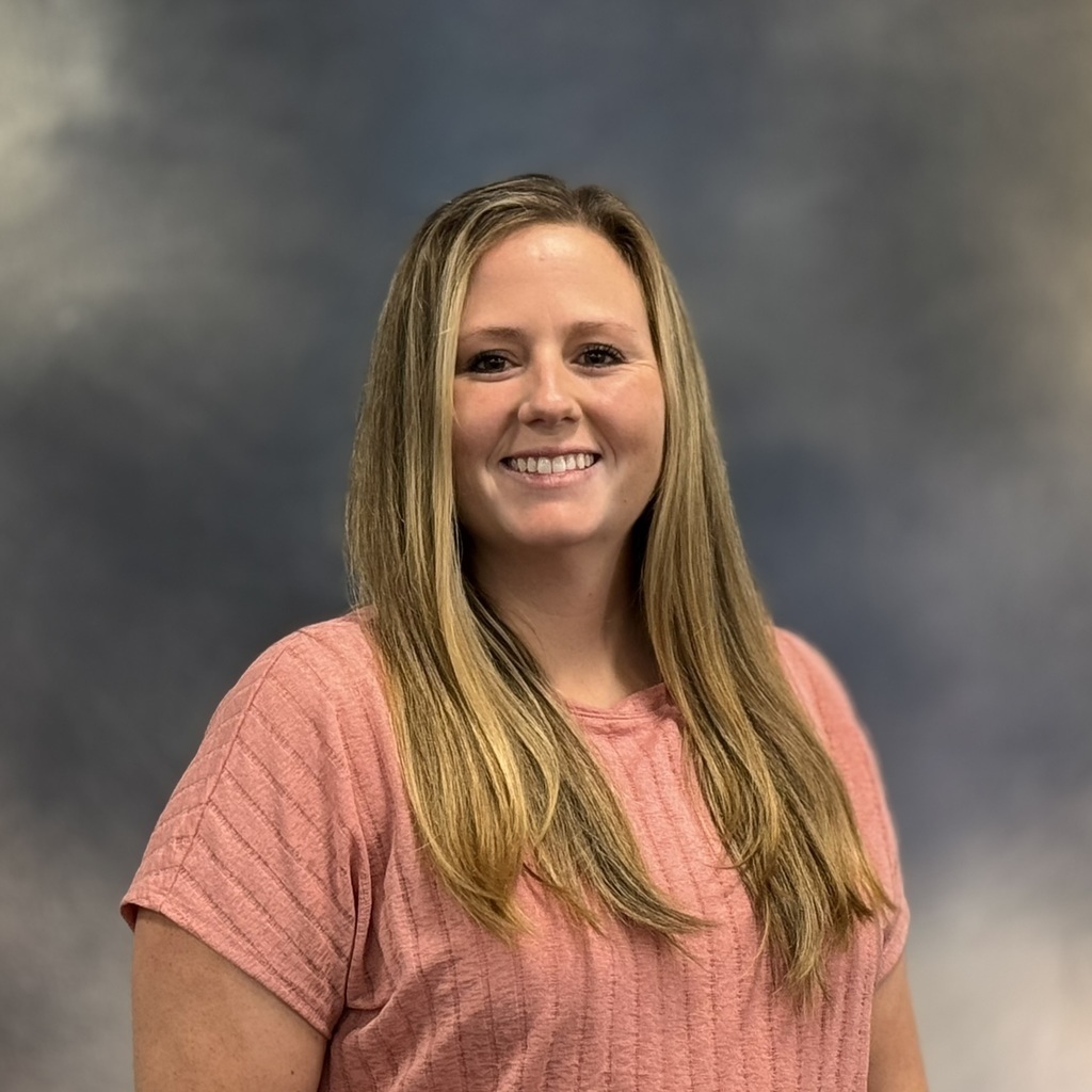 Lady smiling in pink shirt. 