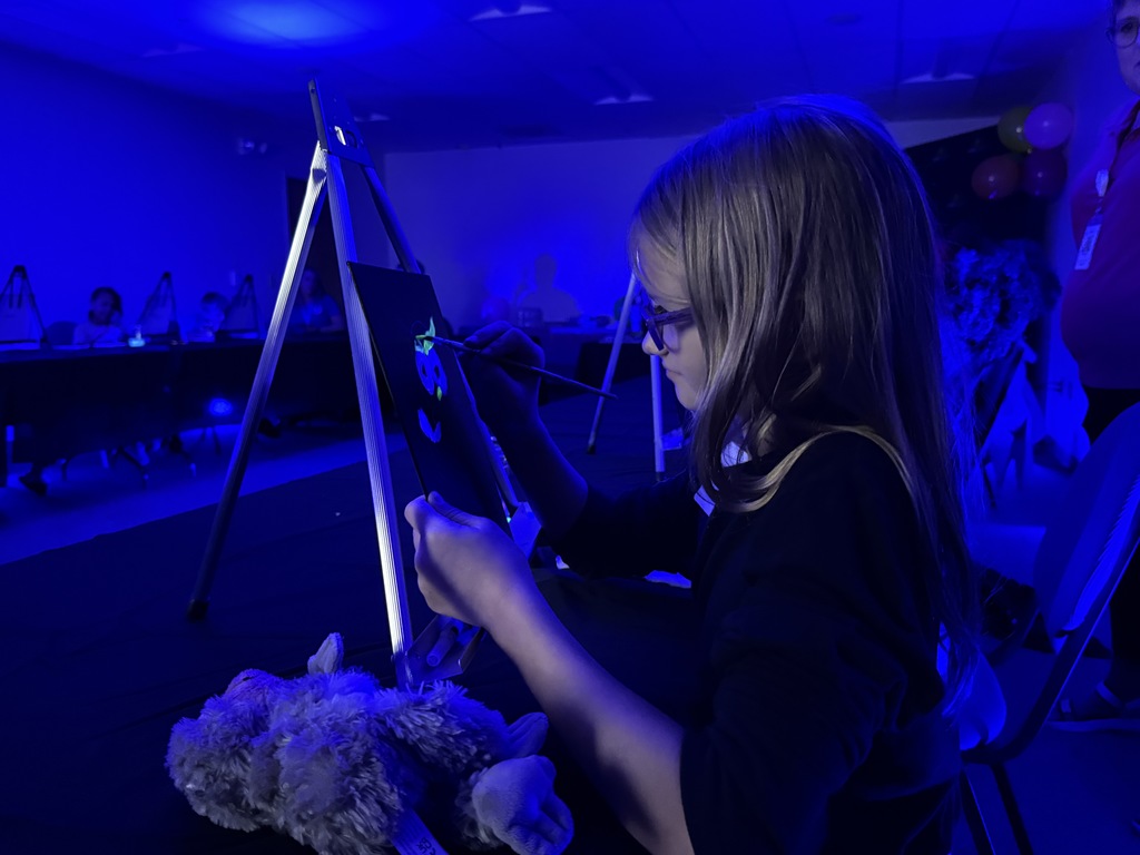 Young female student painting. 
