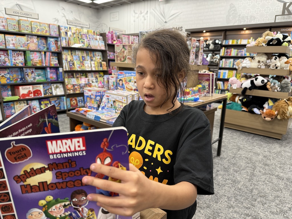 Young female student reads at Books-A-Million. 
