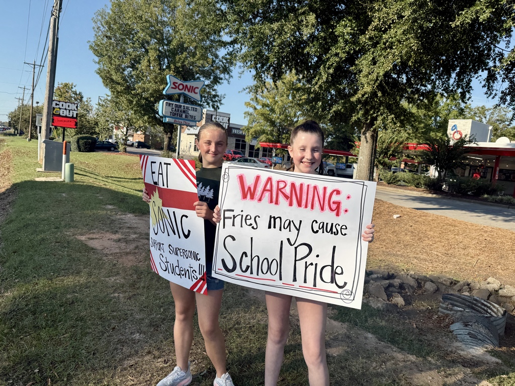 Students holding signs at Sonic.