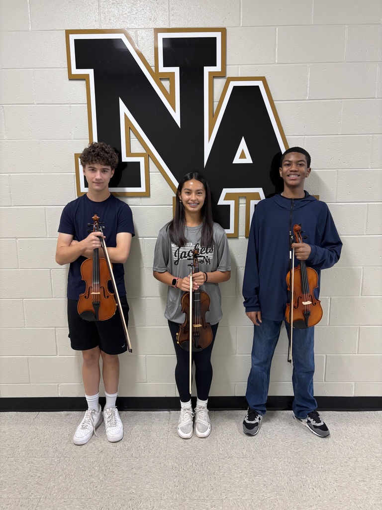3 Students posing with string instruments.
