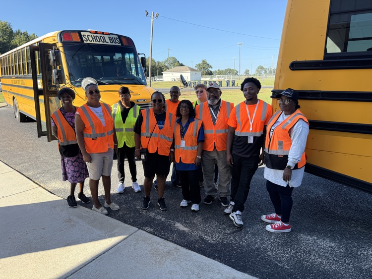 a group of bus drivers posing for a picture