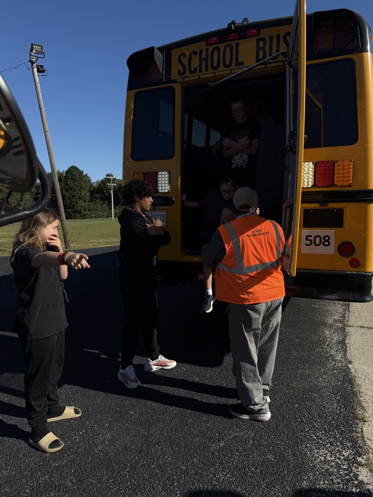 students practicing getting off a bus