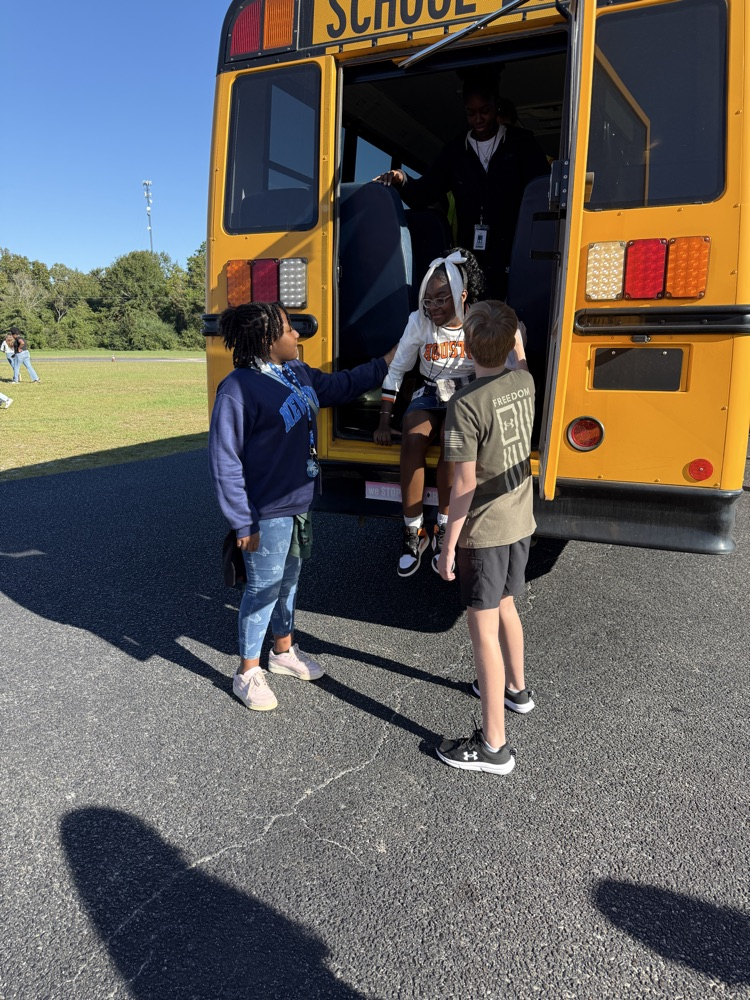 students practicing getting off a bus