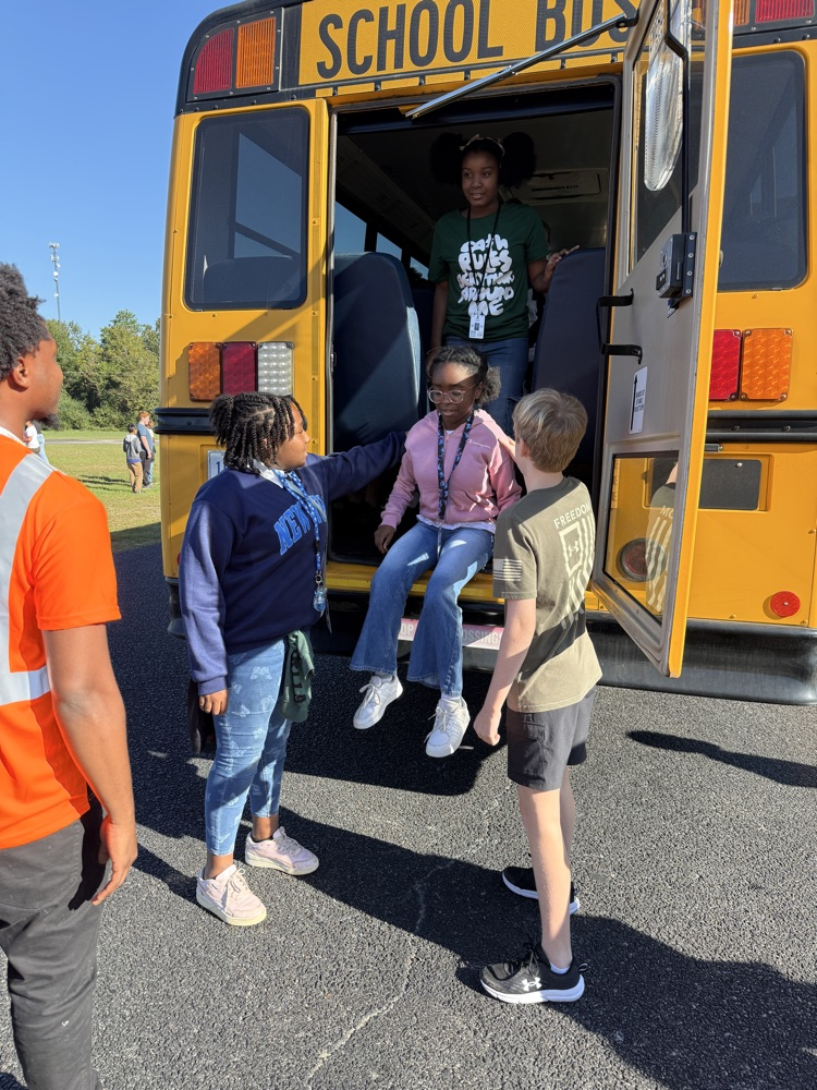 students practicing getting off a bus