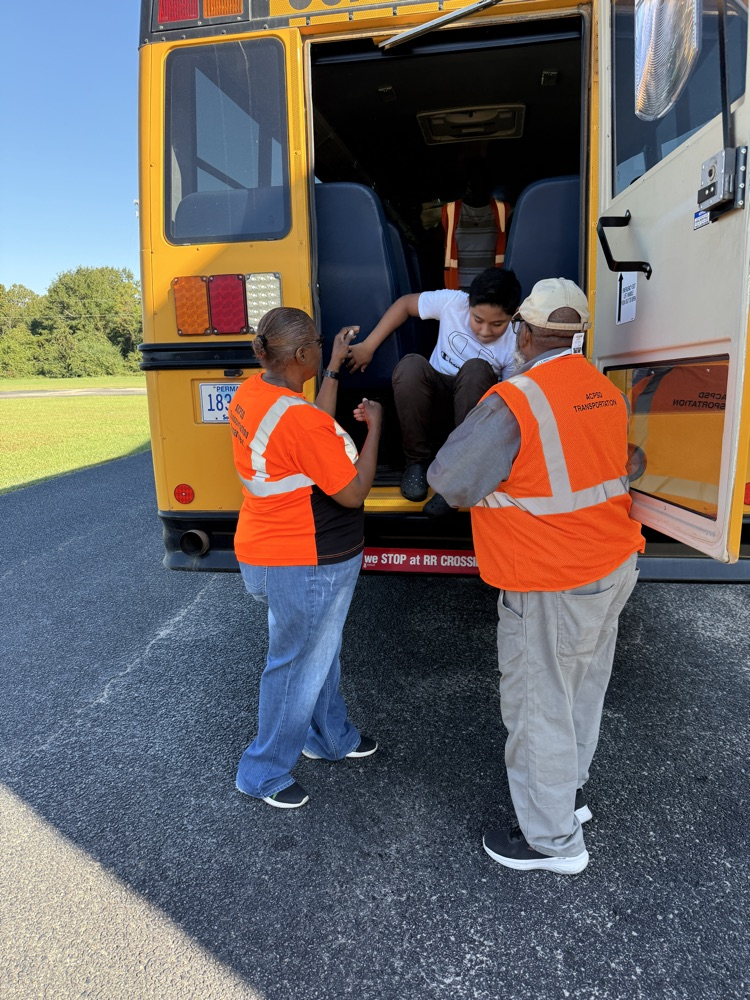 students practicing getting off a bus