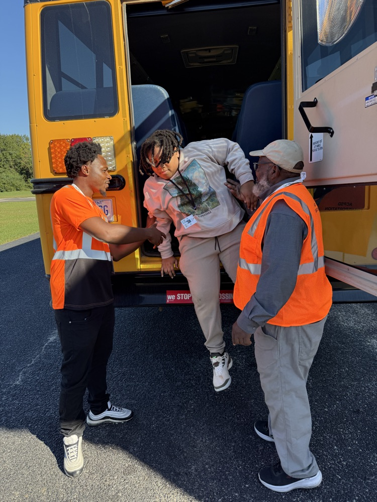 students practicing getting off a bus