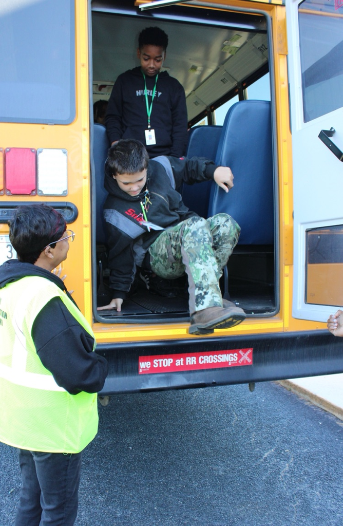 students practicing getting off a bus