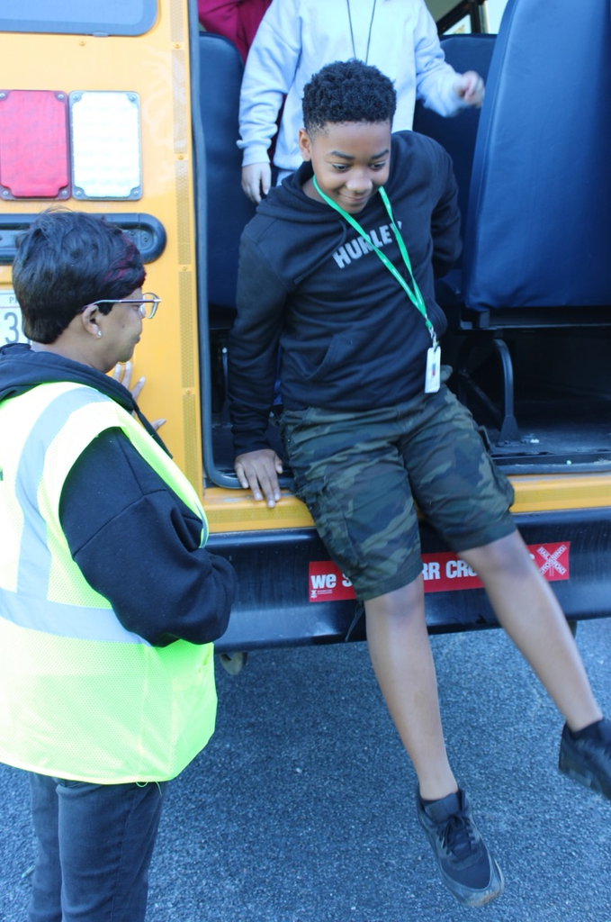 students practicing getting off a bus