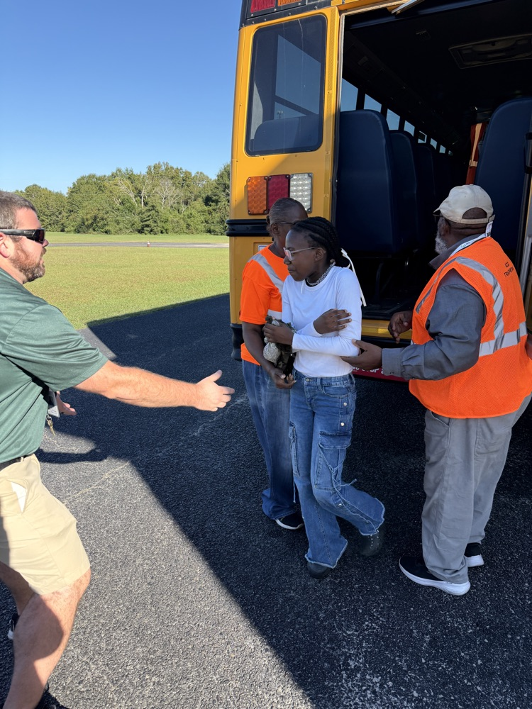 students practicing getting off a bus