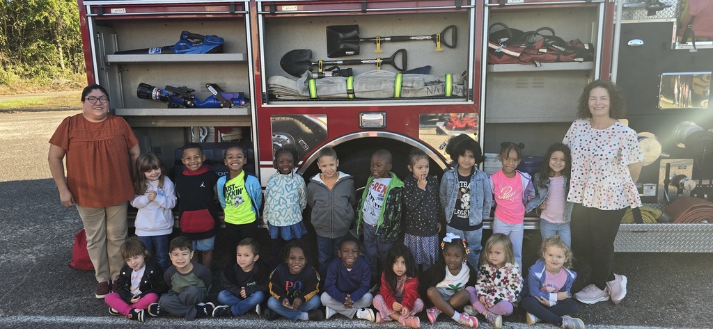 4k students and teachers standing next to fire truck.